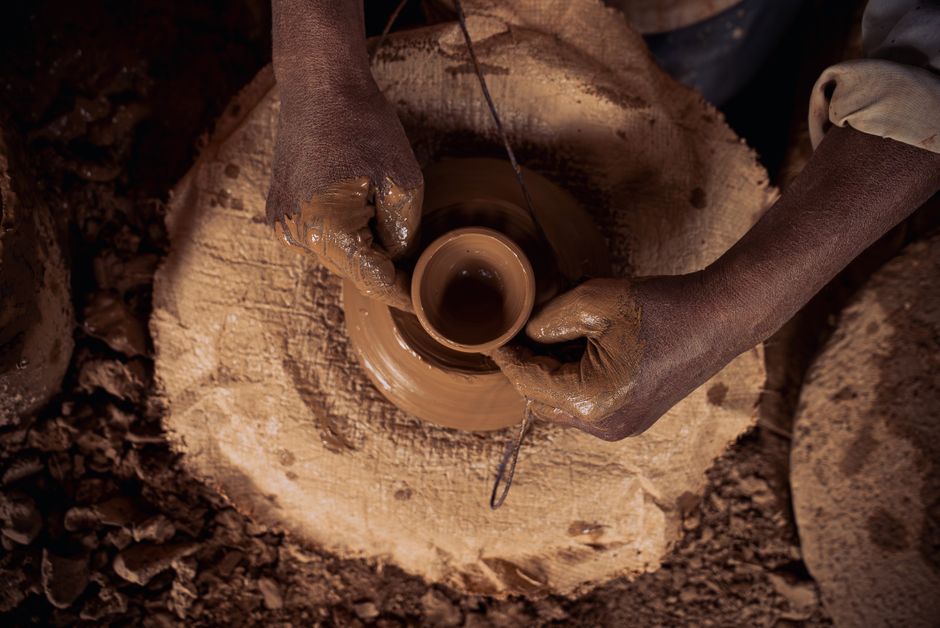 A small pot taking shape on a dim wheel